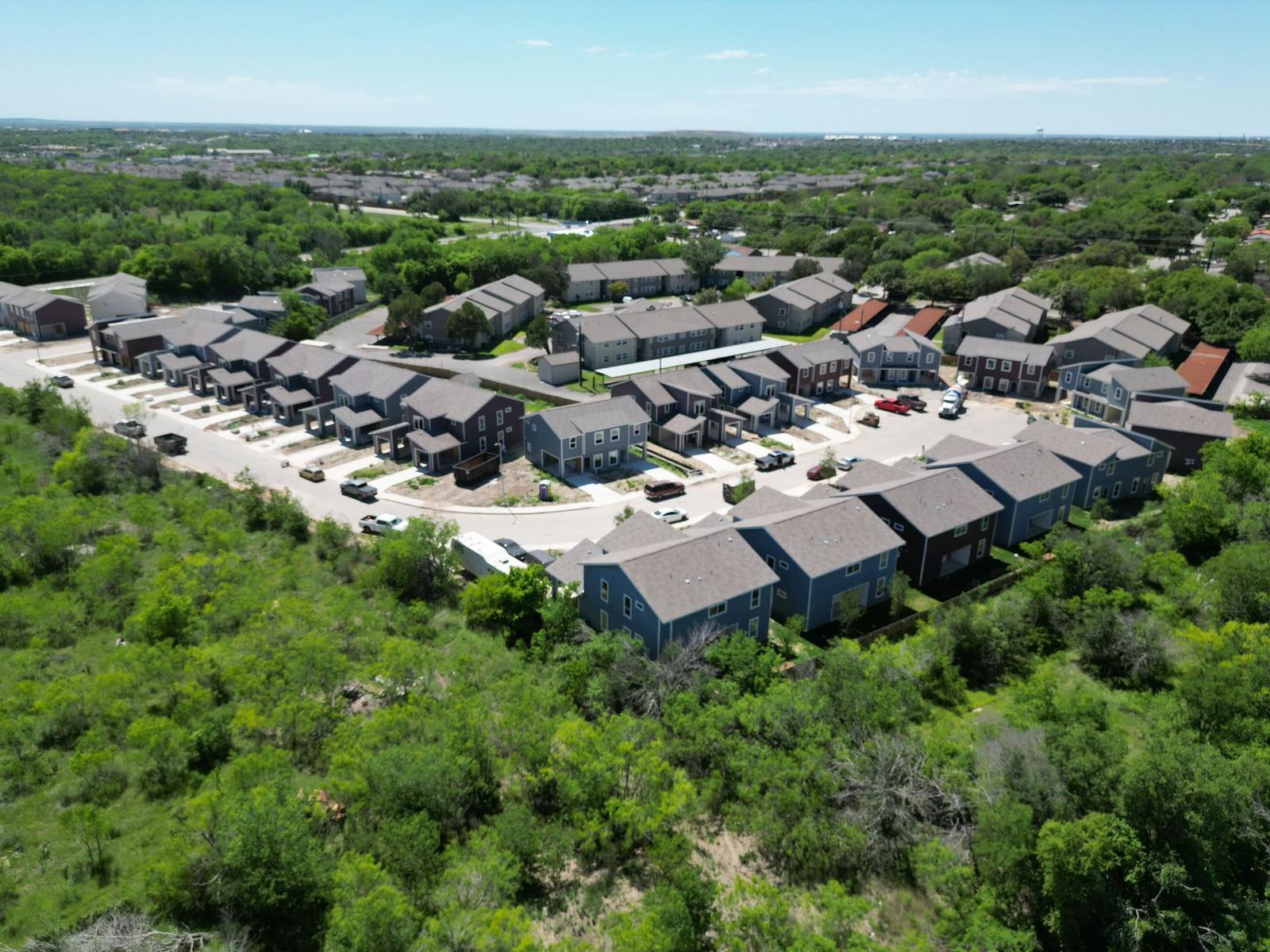 Aerial view of a San Antonio apartment community bordered by green space